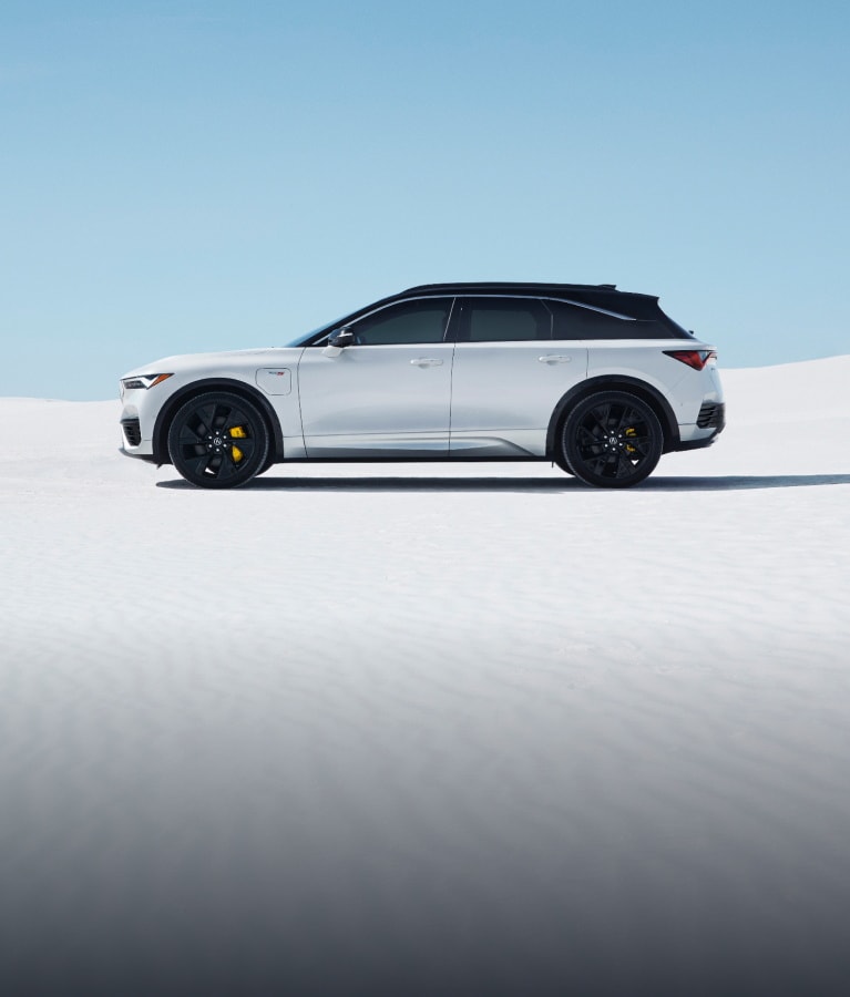2024 Acura ZDX Type S in Snowfall Pearl profile view in sandy background