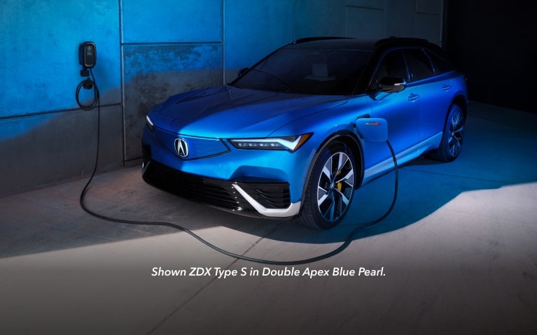 2024 Acura ZDX Type S in Double Apex Blue Pearl next to charging station