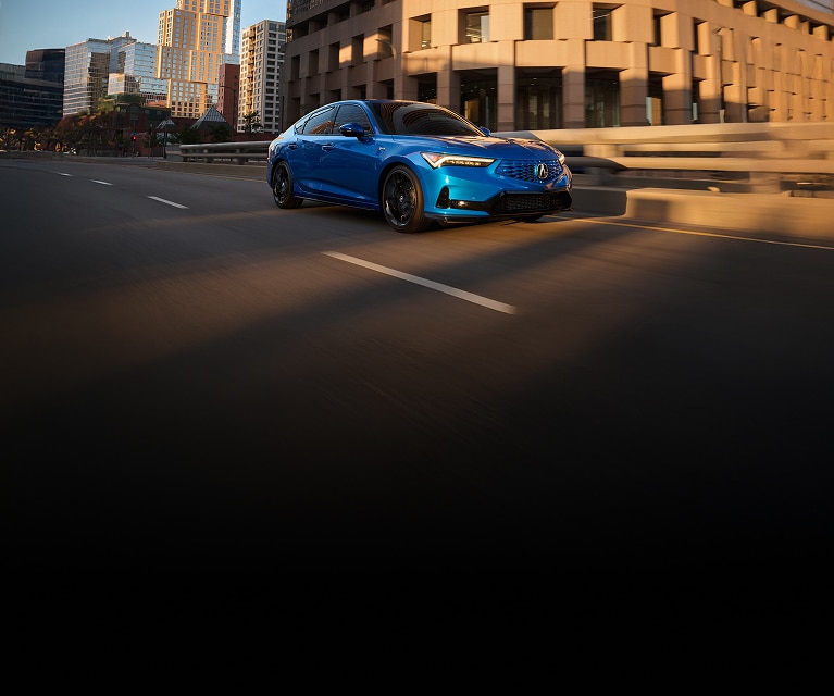 2026 Acura Integra A-Spec with Technology in Double Apex Blue Pearl front driving on a city street. (Premium Sport Compact).