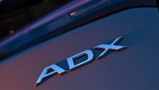 2026 Acura ADX back close up of the rear emblem at dusk (Premium Compact SUV).