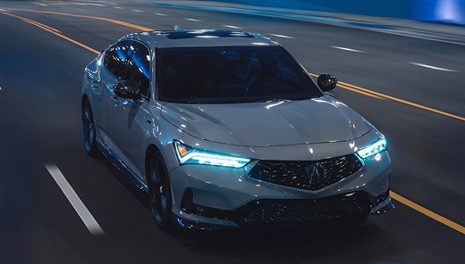 2026 Acura Integra A-Spec with Technology Package in Urban Gray Pearl front driving through a city tunnel (Premium Sport Compact).