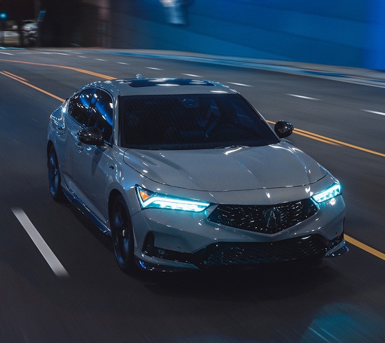 2026 Acura Integra A-Spec with Technology Package in Urban Gray Pearl front driving through a city tunnel (Premium Sport Compact).