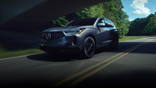2025 Acura RDX front driver view driving on the road