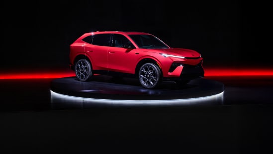 2026 Acura Hybrid 7/8 front on a dark studio stage with red lighting accents.