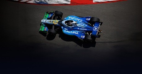 2026 Acura presence at the Indy 500 race, featuring a race car shown from an overhead view.