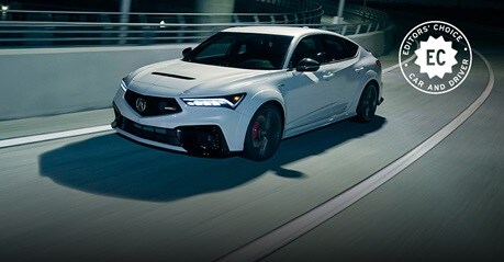 2026 Acura Integra Type S in Platinum White Pearl front driving on a curved highway at night (Premium Sport Compact).