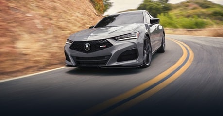 2025 Acura TLX Type S in Urban Gray Pearl, front 3/4 angle, driving on canyon road.