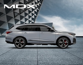2026 Acura MDX Type S profile view with modern building on the background in Urban Gray Pearl
